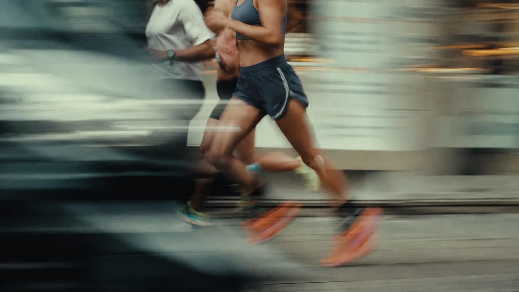 A woman running, caught mid-stride in motion blur.